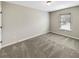 Cozy bedroom with carpeted floors, a window, and neutral wall paint at 6001 Oak Bend Ct, Riverdale, GA 30296