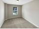 Bedroom featuring a neutral color palette, carpet flooring, and a single window at 6001 Oak Bend Ct, Riverdale, GA 30296