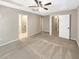 Primary bedroom showcases a tray ceiling and neutral colors with doorway to bathroom at 6001 Oak Bend Ct, Riverdale, GA 30296