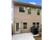 Rear exterior view showing tan siding, a back door, and a visible AC unit at 6001 Oak Bend Ct, Riverdale, GA 30296