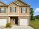 Charming two-story townhome with beige siding, brick accents, and a single-car garage at 6001 Oak Bend Ct, Riverdale, GA 30296