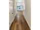 Bright hallway with wood-look flooring and white doors creating a modern, clean design at 6001 Oak Bend Ct, Riverdale, GA 30296