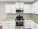 Kitchen featuring stainless steel appliances, a granite countertop and white cabinets at 6001 Oak Bend Ct, Riverdale, GA 30296