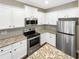 Beautiful kitchen with white cabinets, stainless steel appliances, and granite countertops at 6001 Oak Bend Ct, Riverdale, GA 30296