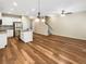 Open-concept space with an island kitchen, staircase, and wood-look flooring at 6001 Oak Bend Ct, Riverdale, GA 30296