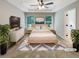 Serene main bedroom with tray ceiling, plush carpet, TV, and natural light at 6001 Oak Bend Ct, Riverdale, GA 30296
