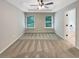 Bright main bedroom with plush carpet, tray ceiling, and ensuite bathroom at 6001 Oak Bend Ct, Riverdale, GA 30296