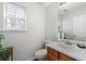 Clean half bathroom with a classic vanity and a mirror at 6606 Coventry Pt, Austell, GA 30168