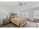 Vaulted ceiling bedroom showcasing a bed with decorative pillows and side tables with lamps at 6606 Coventry Pt, Austell, GA 30168