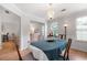 The dining room has a chandelier, and hardwood floors with windows at 6606 Coventry Pt, Austell, GA 30168