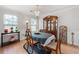 Formal dining room with elegant chandelier, natural light, and decorative shelving at 6606 Coventry Pt, Austell, GA 30168