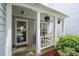 Welcoming covered front porch with white columns and a seating area at 6606 Coventry Pt, Austell, GA 30168