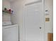 Clean laundry room featuring a washing machine and a door to another part of the house at 6606 Coventry Pt, Austell, GA 30168