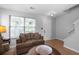 Bright and airy living room with hardwood floors, staircase, and plenty of natural light at 6606 Coventry Pt, Austell, GA 30168