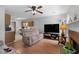 Comfortable living room features a ceiling fan, a TV, and a decorative fireplace at 6606 Coventry Pt, Austell, GA 30168