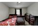This bedroom has a crib, bed, dresser, overhead fan lighting, and a window at 2090 Marbut Ln, Lithonia, GA 30058