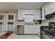 The kitchen has white cabinets, stainless steel appliances, and an adjacent door at 2090 Marbut Ln, Lithonia, GA 30058