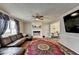 Inviting living room with a brick fireplace, plush seating, large rug, and natural light streaming through the windows at 2090 Marbut Ln, Lithonia, GA 30058