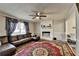 Spacious living room with a leather sectional sofa, fireplace, and bright windows at 2090 Marbut Ln, Lithonia, GA 30058