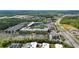 Beautiful aerial view of the surrounding neighborhood featuring a baseball stadium, nearby shopping, and green trees at 2625 Cedar Dr, Lawrenceville, GA 30043