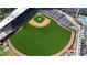 Aerial view of a well maintained baseball field with green grass, red clay, and covered stadium seating at 2625 Cedar Dr, Lawrenceville, GA 30043