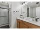 Bathroom featuring a double vanity with a granite countertop, bronze hardware, and a walk-in shower at 2625 Cedar Dr, Lawrenceville, GA 30043