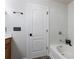 Bathroom featuring a tub, granite countertop, bronze hardware, and new white paint at 2625 Cedar Dr, Lawrenceville, GA 30043