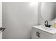 This simple bathroom boasts a stylish sink with a modern faucet and cabinet at 2625 Cedar Dr, Lawrenceville, GA 30043