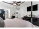 Modern bedroom featuring a stylish canopy bed, sleek black dressers, and a wall-mounted TV at 2625 Cedar Dr, Lawrenceville, GA 30043