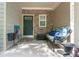Inviting front porch with a decorative stone accent wall, a cozy bench, and a welcoming entrance at 2625 Cedar Dr, Lawrenceville, GA 30043