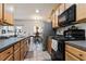 Charming kitchen with wooden cabinets and tiled floors, perfect for everyday meals at 2625 Cedar Dr, Lawrenceville, GA 30043