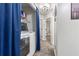 Well-organized laundry area with washer, dryer, storage, and blue privacy curtains at 2625 Cedar Dr, Lawrenceville, GA 30043