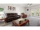 Cozy living room featuring a leather sofa and large windows, perfect for Gathering gatherings at 2625 Cedar Dr, Lawrenceville, GA 30043