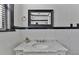 Bathroom features black and white design with a marble countertop vanity and a tiled wall with a mirror at 301 10Th Ne St # 12, Atlanta, GA 30309