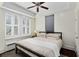 Bright bedroom with a modern black bed frame, tray ceiling, and large windows with classic white shutters at 301 10Th Ne St # 12, Atlanta, GA 30309