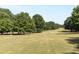 Expansive golf course view with lush green grass and mature trees, offering a serene and picturesque landscape at 301 10Th Ne St # 12, Atlanta, GA 30309