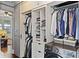 Hallway closet area contains front loading washer/dryer and shelving for cleaning and laundry products at 301 10Th Ne St # 12, Atlanta, GA 30309