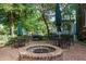 A brick patio features outdoor seating around a fire pit, with mature trees offering ample shade at 301 10Th Ne St # 12, Atlanta, GA 30309
