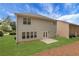 The home's backyard features a well-maintained lawn, neutral siding, and double doors leading inside at 3208 Juniper Nw Dr, Kennesaw, GA 30144