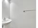 Clean bathroom with a sleek pedestal sink and a stylish chrome towel bar at 3208 Juniper Nw Dr, Kennesaw, GA 30144