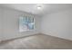 Light-filled bedroom with plush carpeting, a window offering natural light, and neutral walls at 3208 Juniper Nw Dr, Kennesaw, GA 30144
