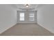 Comfortable bedroom with a tray ceiling, carpeted flooring, and bright windows at 3208 Juniper Nw Dr, Kennesaw, GA 30144