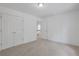 Neutral-toned bedroom features a double door closet, an open entry, and plush carpeting at 3208 Juniper Nw Dr, Kennesaw, GA 30144