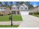 Charming two-story home with a well-manicured lawn and a two-car garage at 3208 Juniper Nw Dr, Kennesaw, GA 30144