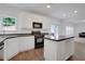 Bright kitchen with white cabinets, black appliances, and hardwood floors at 3208 Juniper Nw Dr, Kennesaw, GA 30144