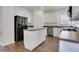 Modern kitchen featuring white cabinets, stainless steel appliances, and a center island at 3208 Juniper Nw Dr, Kennesaw, GA 30144
