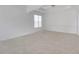 Bright living room with white walls, neutral carpet and decorative molding at 3208 Juniper Nw Dr, Kennesaw, GA 30144