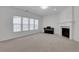Cozy living room featuring a fireplace and natural light from large windows at 3208 Juniper Nw Dr, Kennesaw, GA 30144