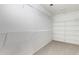 Spacious walk-in closet with white wire shelving, offering ample storage space in a carpeted room at 3208 Juniper Nw Dr, Kennesaw, GA 30144