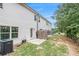 Backyard with a small patio, fenced area, green grass, and the building's exterior at 7762 Fawn Cir, Covington, GA 30014